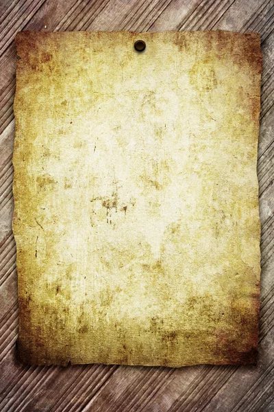 Old paper sheet on wooden background — Stock Photo, Image