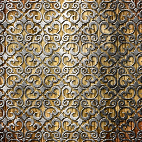 Ornamento in metallo su vecchio sfondo di legno — Foto Stock