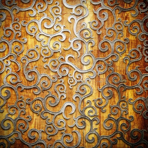 Metallornament auf altem Holzgrund — Stockfoto