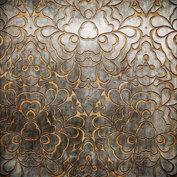 Metal ornament on old wooden background — Stock Photo, Image