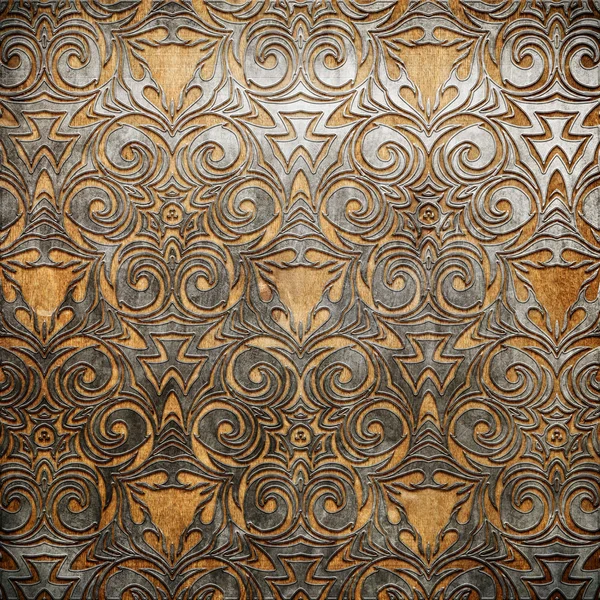 Metal ornament on old wooden background — Stock Photo, Image