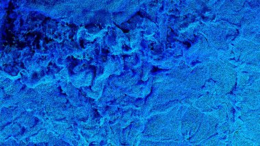 Milyonlarca Minik Mavi Parçacık, ekranı birçok girdap ve küçük dalgalarla dolduruyor.