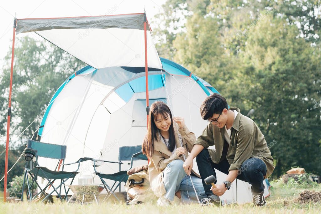 Happy couple camping life at park. Travel and outdoor activity.