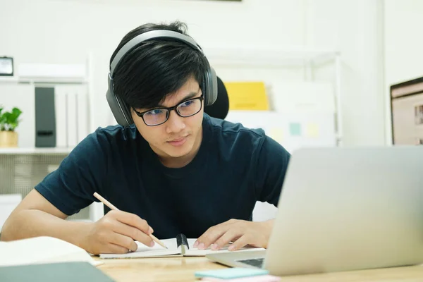 Hombre joven estudio en frente de la computadora portátil en casa — Foto de Stock