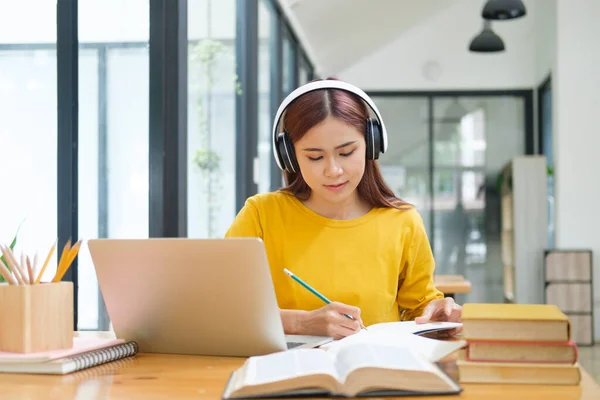 Young collage student using computer and mobile device studying online,Education online learning or self study concept.