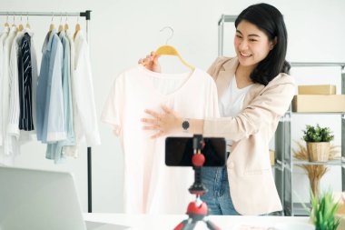 Businesswoman startup giving important pieces of advice while streaming video for womens clothing. Online Business Ideas and Freelance.