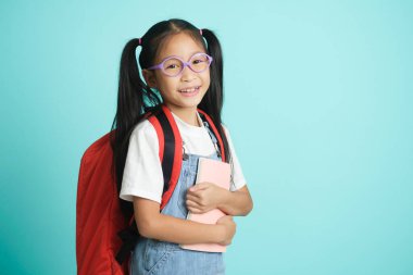 Kid students girl smiling holding book, going to school. school concept.
