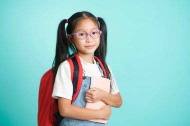 Kid students girl smiling holding book, going to school. school concept.