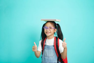 Kid students girl going to school, i like school. Smiling pose for camera on sky blue studio background. school concept.