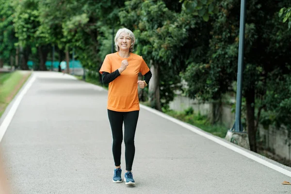 Athletic Asian Senior Woman Running Morning Outdoor Jogging Park — Stock fotografie