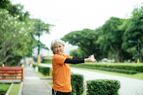 Athletic Senior Woman Jogger Warming Stretching Arms Upper Body Running —  Fotos de Stock