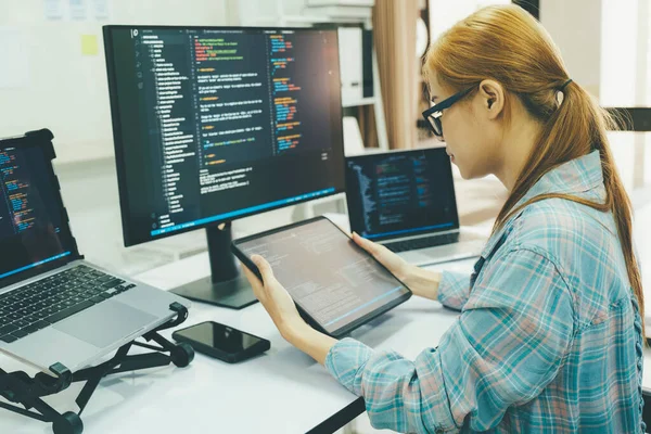 Programmer is coding and programming software. business woman working on computer in the office.