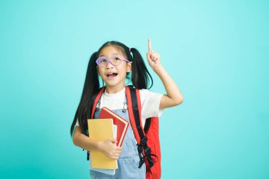 Close-up kid students girl smiling holding book, going to school. school concept.