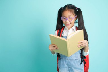 Close-up kid students girl smiling holding book, going to school. school concept.