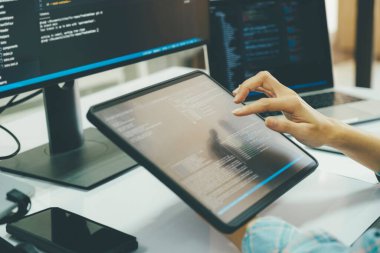 Close up Programmer is coding and programming software. business woman working on computer in the office.