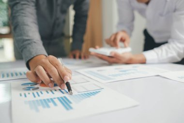 Asisan businessman teamwork meeting and discussing the investment data and report graph Teamwork meeting working concept.