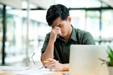 Stressed overwork businessman in the office.