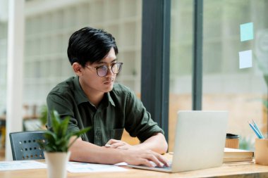 Young asian Startup Businessman planning and analyse investment marketing data.