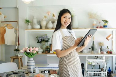 Young businesswoman start up checking inventory in small business.Businesswoman checking inventory in stock room on laptop. Store house inspection.