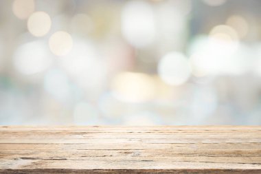 Kahve dükkanındaki mevcut ürün için boş ahşap masa ya da Bokeh imajı olan yumuşak içecek bar bulanık arkaplan.