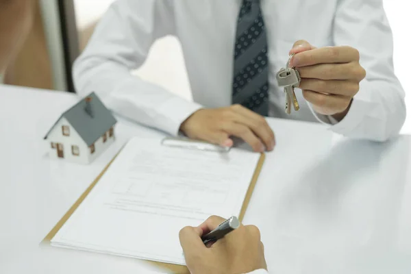 地产代理在与客户商谈签订房屋贷款合同 财产保险后 将房子钥匙交给客户 房地产概念 — 图库照片