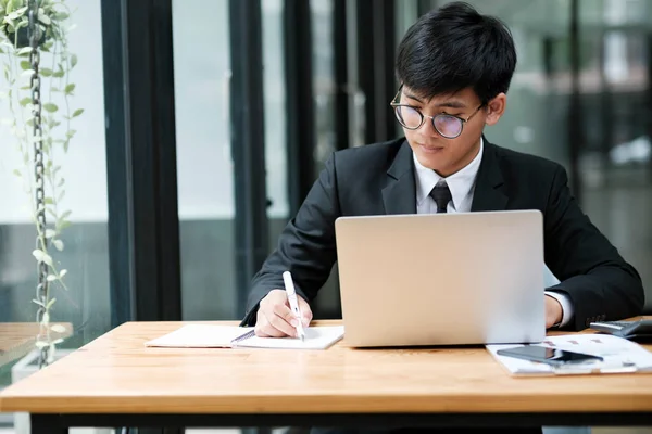 Young Asian Businessman Working Hard Office Using Laptop Data Graphs — Stock Photo, Image