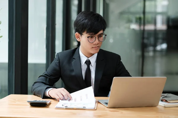 Young Asian Businessman Working Hard Office Using Laptop Data Graphs — Stock Photo, Image