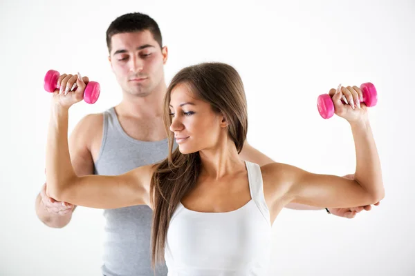 Personal trainer assisting a client — Stock Photo, Image