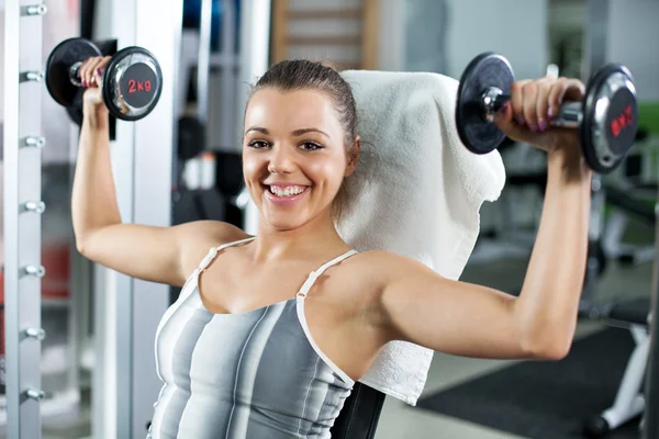 Young woman doing shoulder exercise — Stock Photo, Image