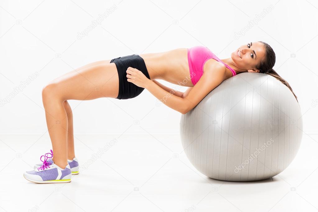Exercising and lifting the weights with Exercise Ball