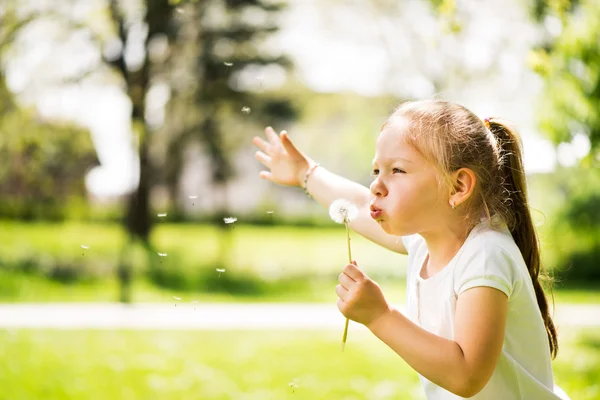 Little girl with a dandelion — Stock Photo, Image