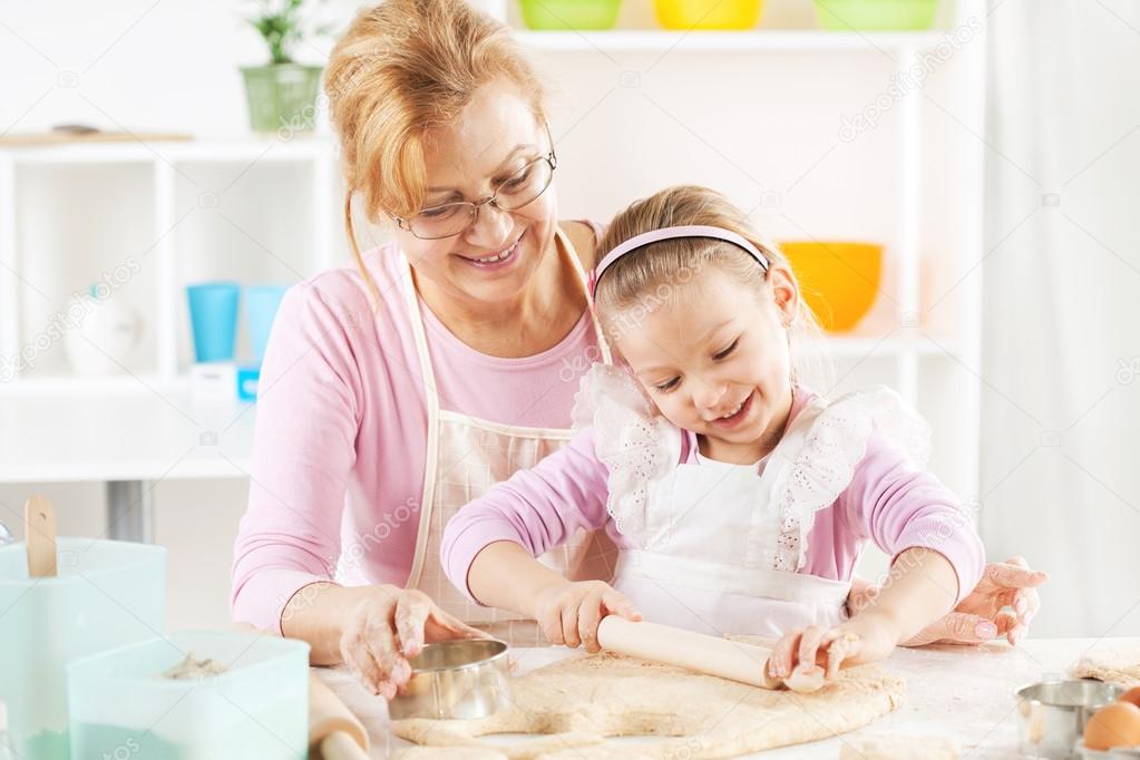 Grandmother and granddaughter making Dough