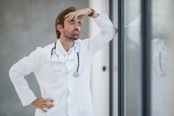 Shot Mature Doctor Looking Stressed While Standing Looking Out Window — Stock Photo, Image