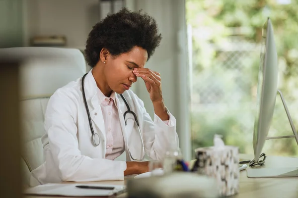 Fotografía Una Doctora Africana Cansada Sentada Sola Escritorio Consultorio Durante —  Fotos de Stock