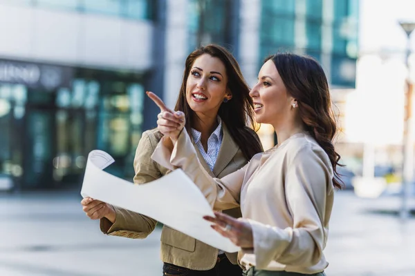 Two Attractive Smiling Businesswoman Engineer Chatting Looking Plans Office — Stock Photo, Image