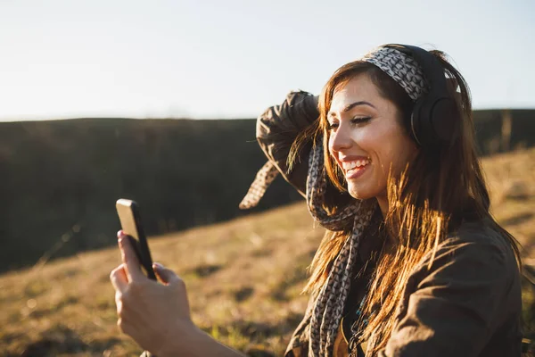 Smiling Young Woman Making Video Call Smartphone While Sitting Ground — Photo