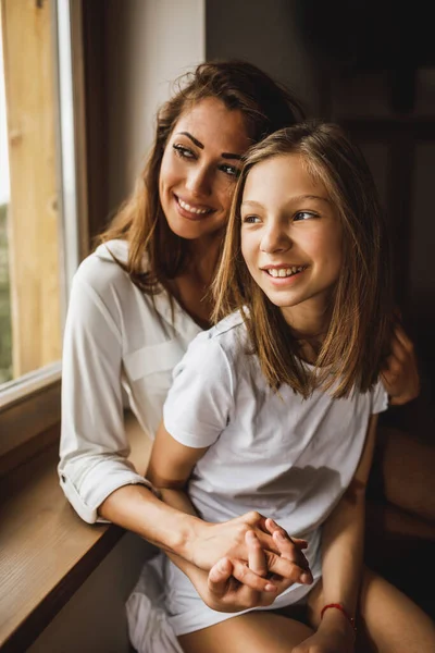 Cute Smiling Girl Her Young Mother Looking Window While Enjoying — Fotografia de Stock