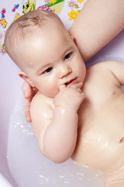 Baby girl having bath Stock Image