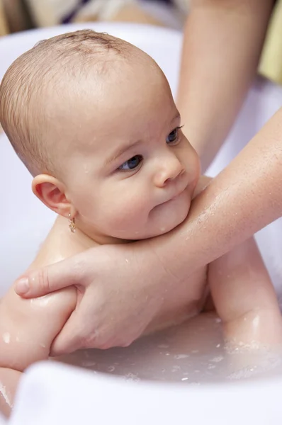 Baby girl having bath Stock Picture