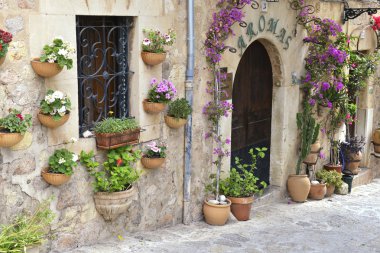 Typical Mediterranean Village with Flower Pots in Facades in Val clipart