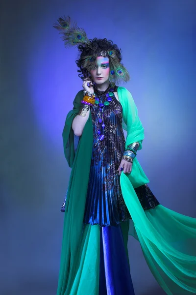 Woman in peacock image. — Stock Photo, Image