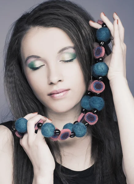 Young woman with beads — Stock Photo, Image