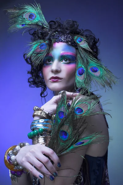 Woman in peacock image. — Stock Photo, Image