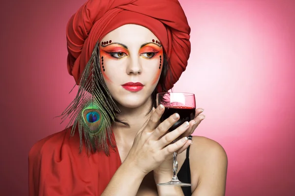 Woman in red turban with peacock plume — Stock Photo, Image