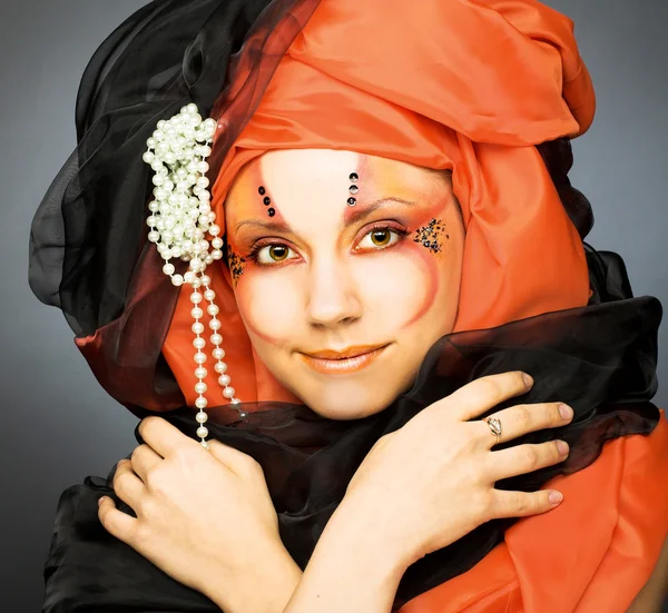 Young woman in black and orange turban — Stock Photo, Image