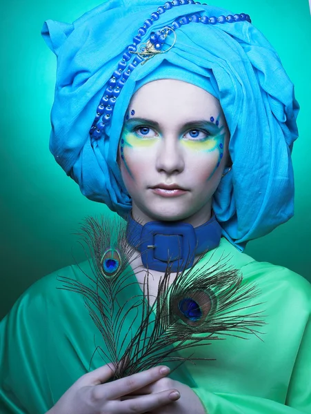 Young woman with peacock feathers — Stock Photo, Image