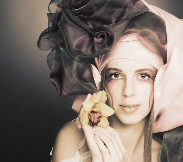 Young lady with orchids — Stock Photo, Image