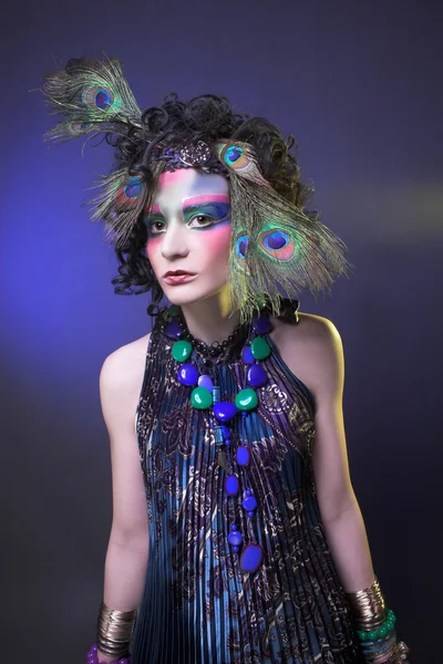 Woman in peacock image. — Stock Photo, Image