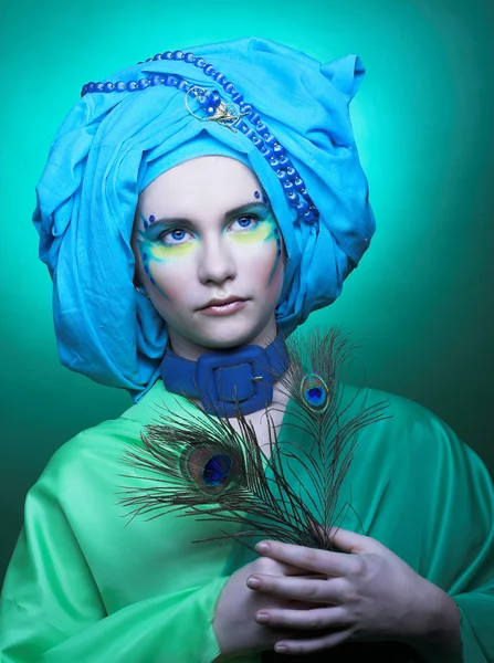 Young woman with peacock feathers — Stock Photo, Image