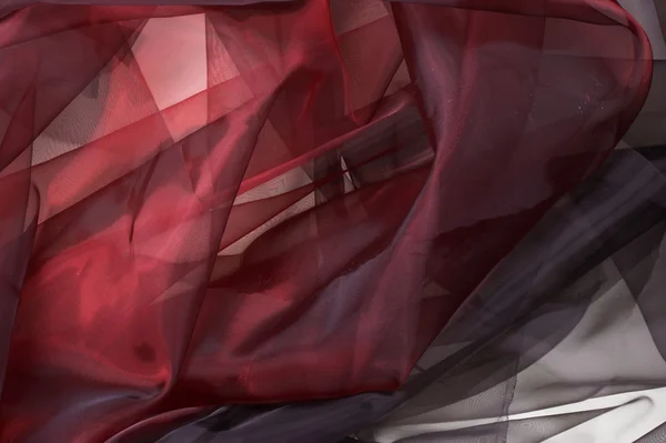 Schwarzer und roter Seidenstoff. schöner künstlerischer Hintergrund. — Stockfoto